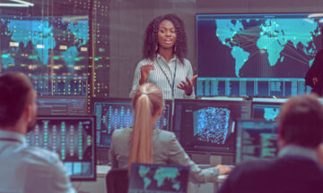 Image of professionals listen to a security leader in a high tech environment