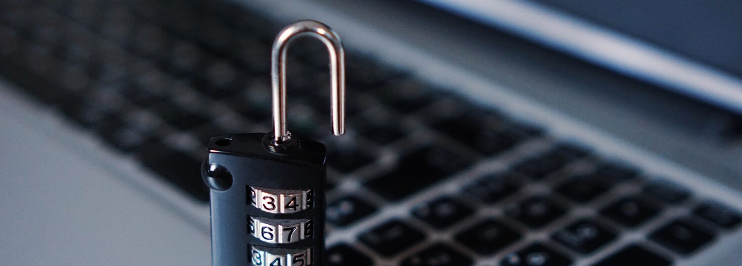 Physical proection image of lock sitting on computer keyboard